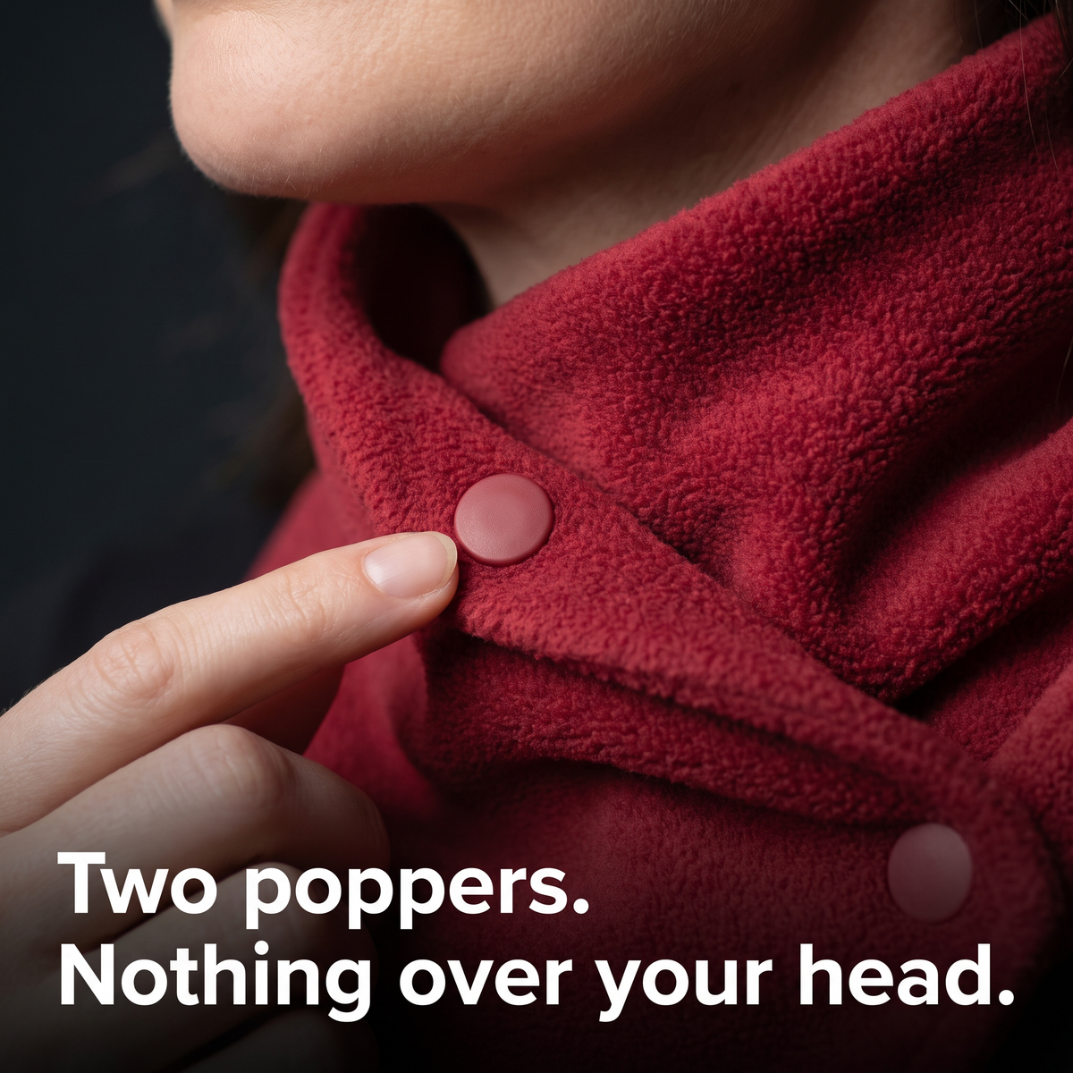 Close-up of the Fleece Snood popper being fastened at the side of the neck