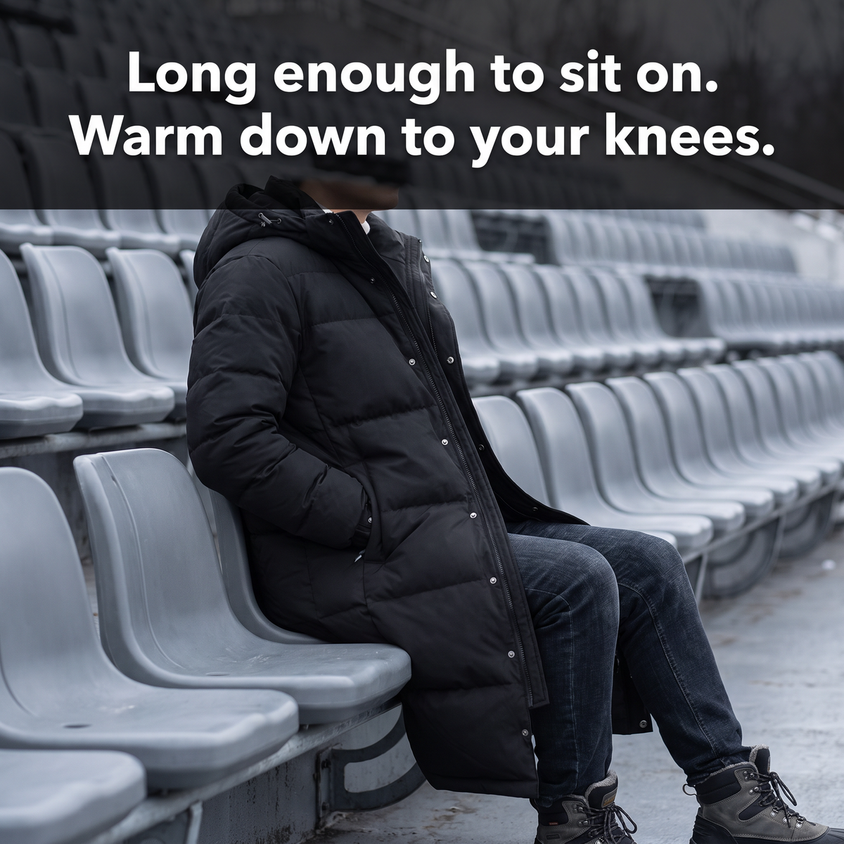 Man sitting on a stadium bench, the long puffer coat covering his thighs