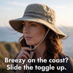 Chin cord toggle slid up under the chin on a breezy clifftop