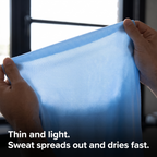 Close-up of the thin, light knit of the men's running top held up to the light