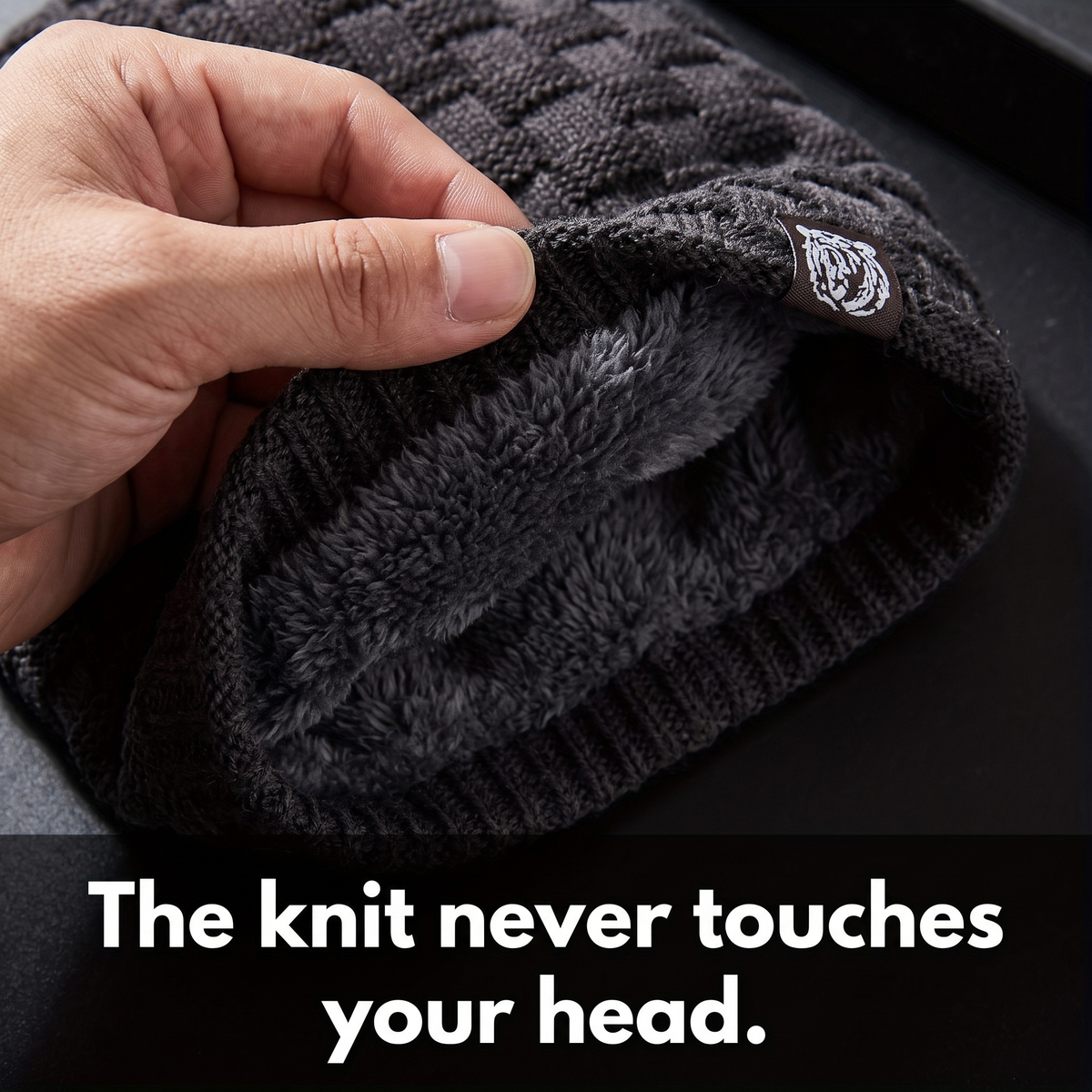 Brim folded back to show the fleece lining against the knit