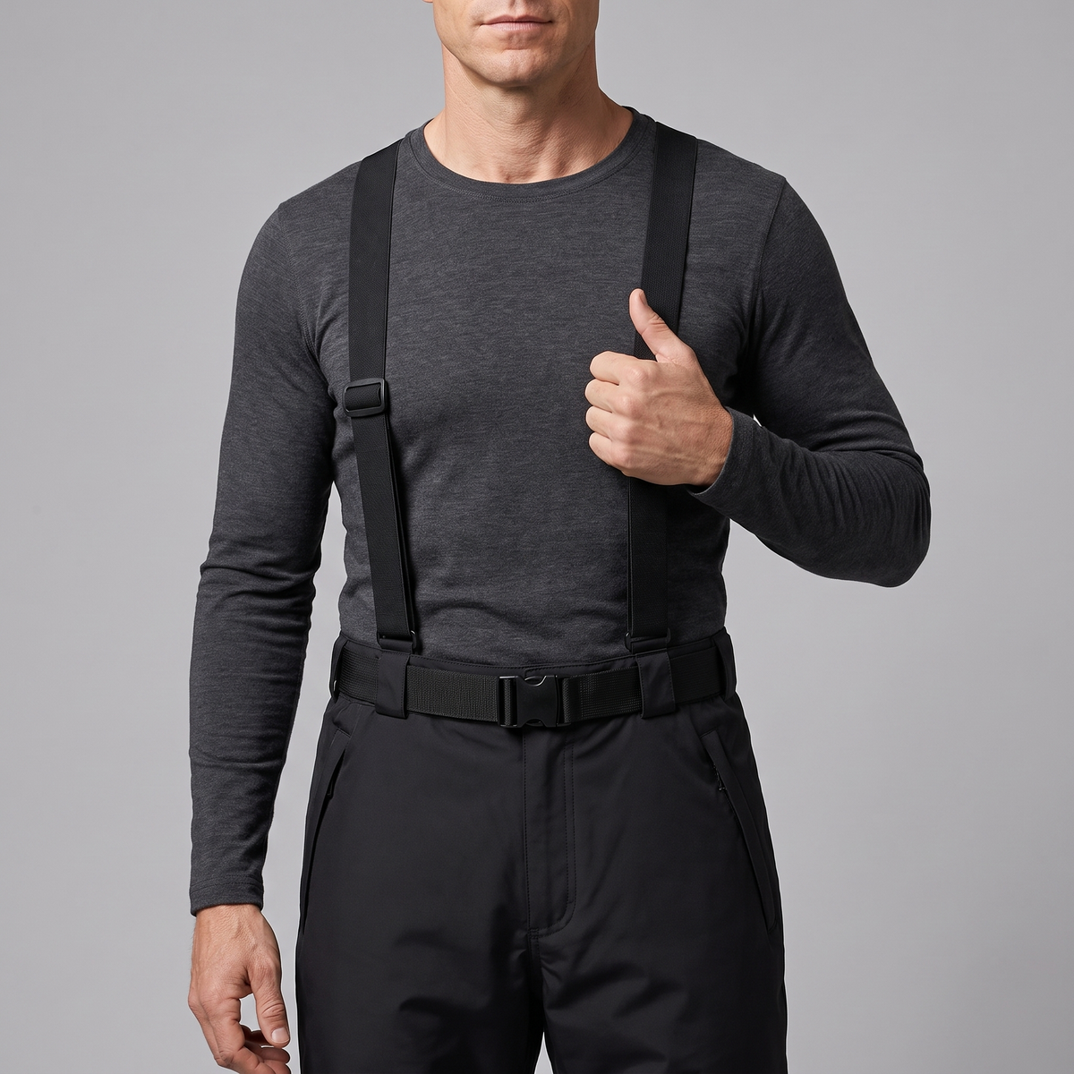 Ski trousers braces and side-release buckle belt worn over a base layer