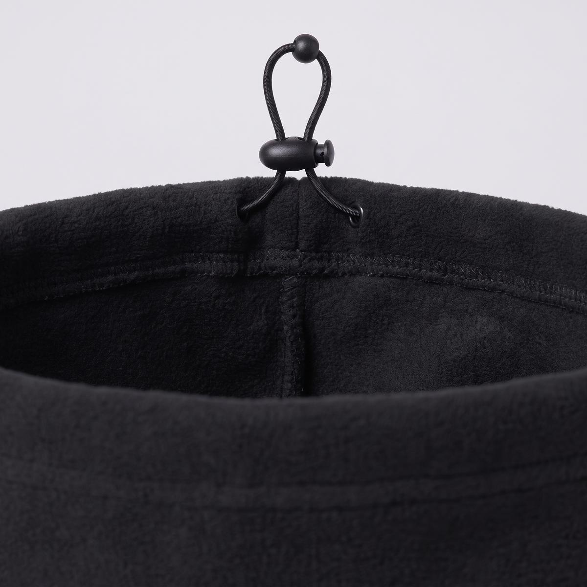 Close-up of the snood's single-layer polar fleece and cord lock