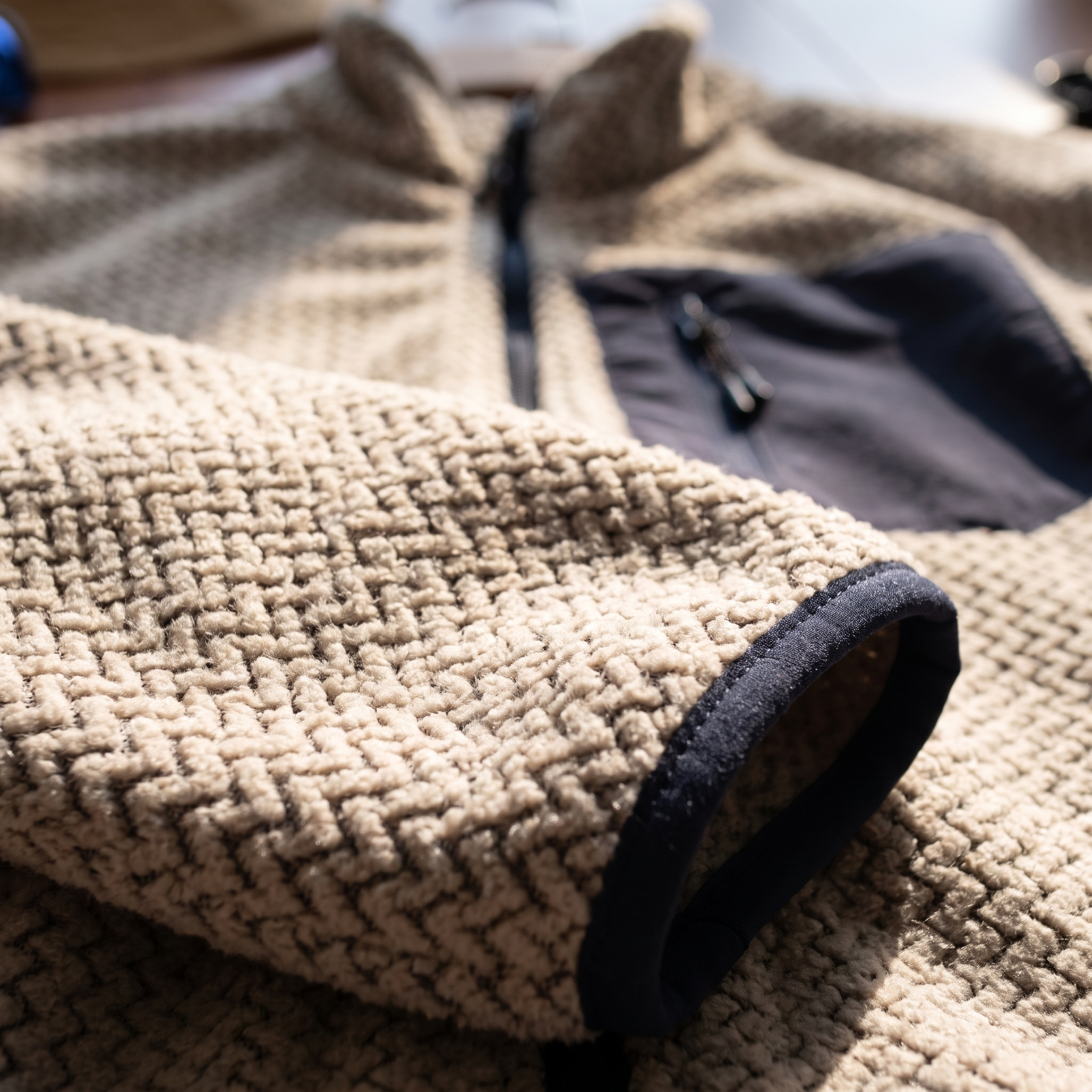 Close-up of the jacquard knit face and the contrast binding at the cuff