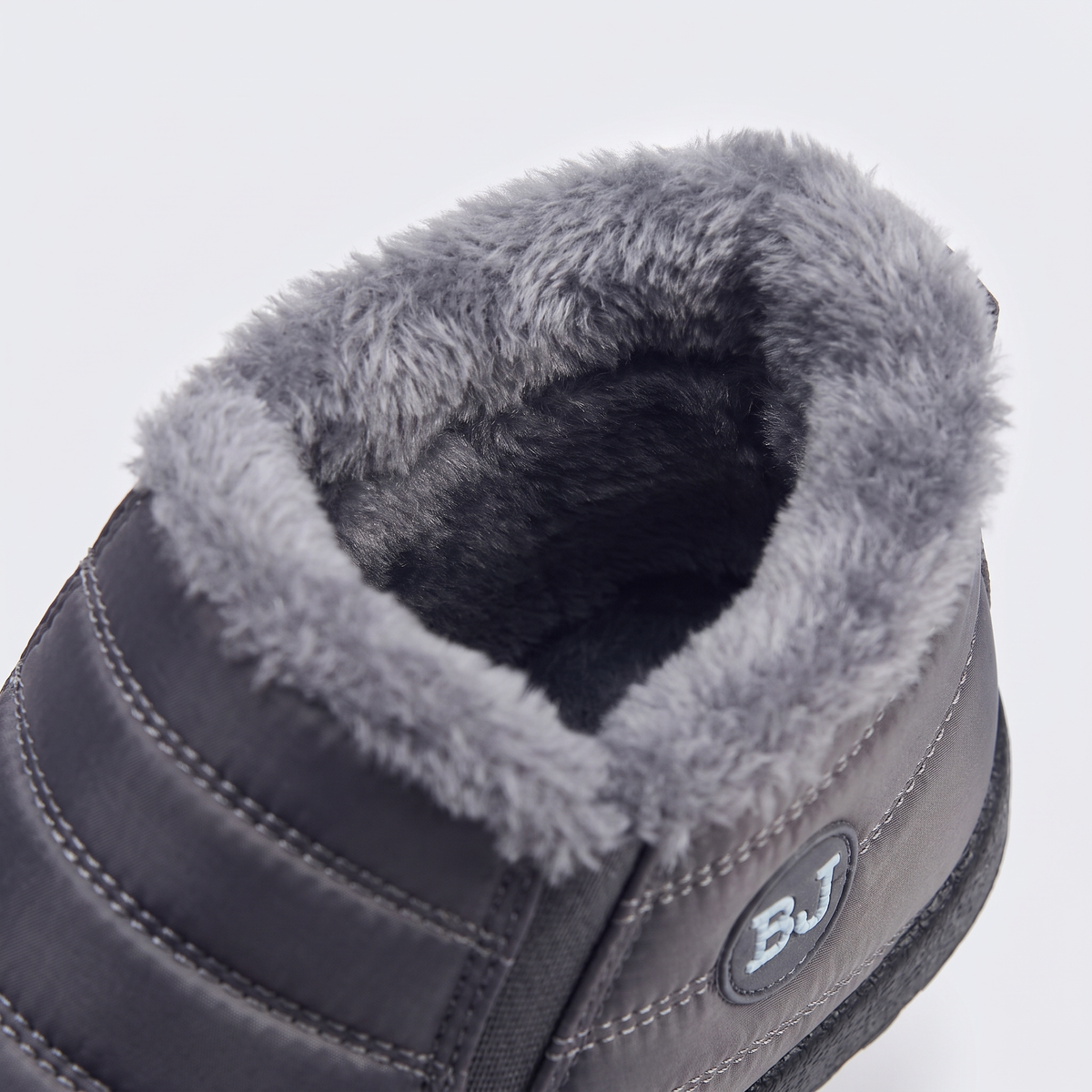 Women's slip-on snow boots: plush faux fur lining and collar, close-up