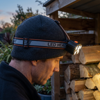 Head torch worn over a knitted woolly hat, adjustable headband, buckle and over-the-head strap