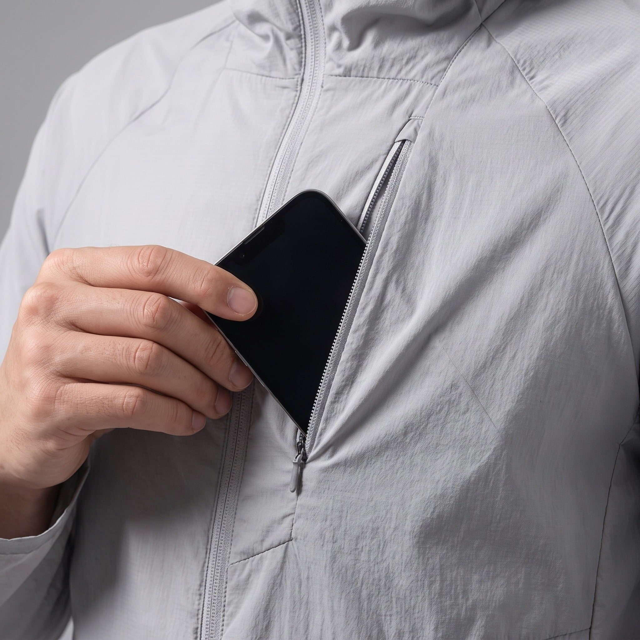 Phone going into the zipped chest pocket
