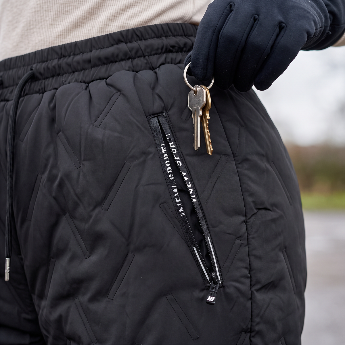 Women's fleece lined quilted trousers: zipped hip pocket with keys