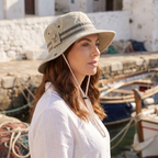 Woman in the Khaki sun hat by a sunny harbour