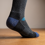 Close-up of the cushioned heel of the thermal ski sock on a wooden floor