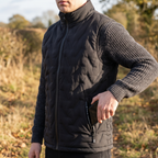 Phone going into the zipped hand pocket of the black body warmer