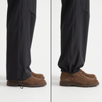 The hem of the women's walking trousers shown two ways side by side, falling open and wide on the left and drawn closed into a cuff on the right