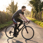 Rider on a country lane at golden hour wearing the cycling tights with a plain t-shirt