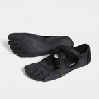 Women's barefoot five toe shoes in black, a pair with one sole turned up to show the toe pads
