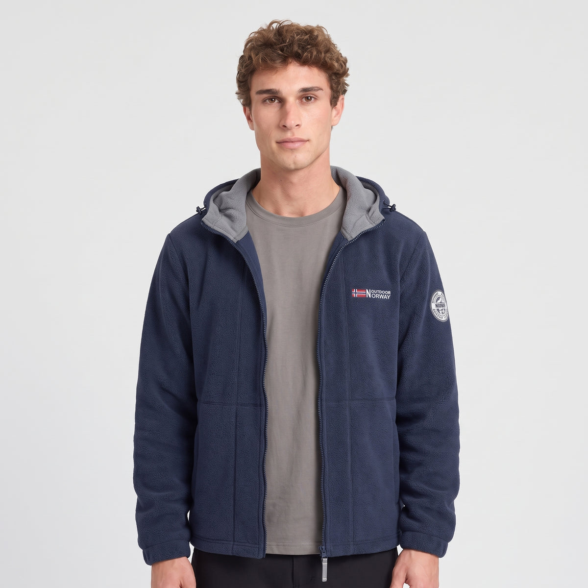 Men's navy blue windproof fleece jacket worn, front view with contrast hood lining