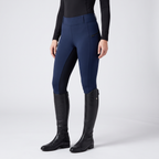 Women's two-tone jodhpurs in navy, pull-on with a wide waistband and a dark inner-leg panel, worn with tall riding boots