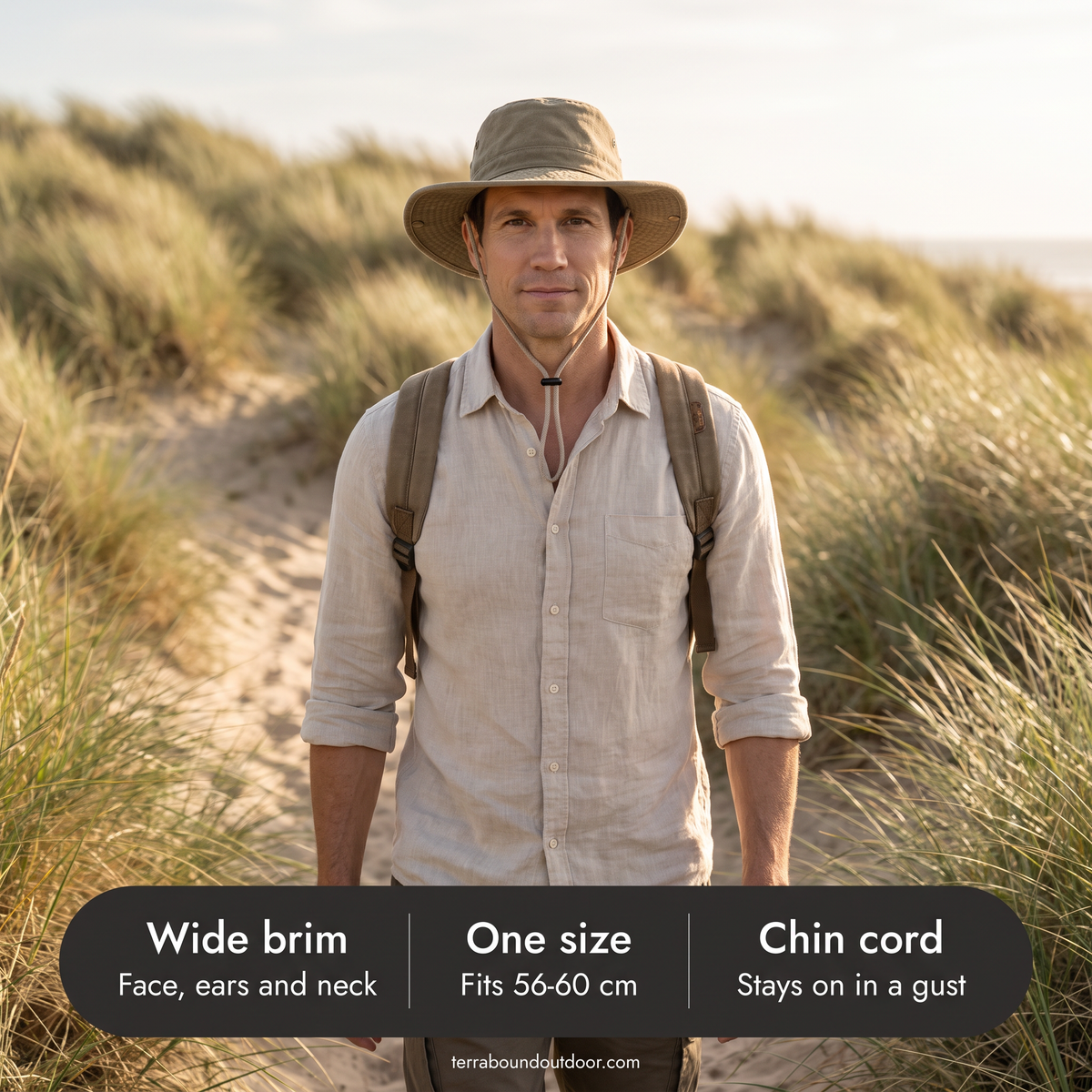 Man on a coastal dune path in the wide brim sun hat with its one size and chin cord details