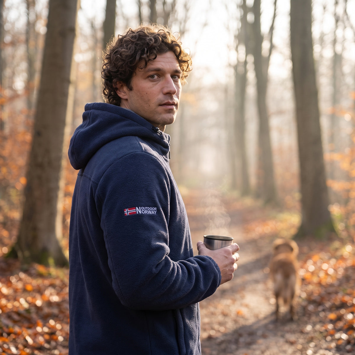 Man stopped on a woodland path in the navy windproof fleece jacket