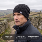 Man on a hill path wearing the beanie, with specifications