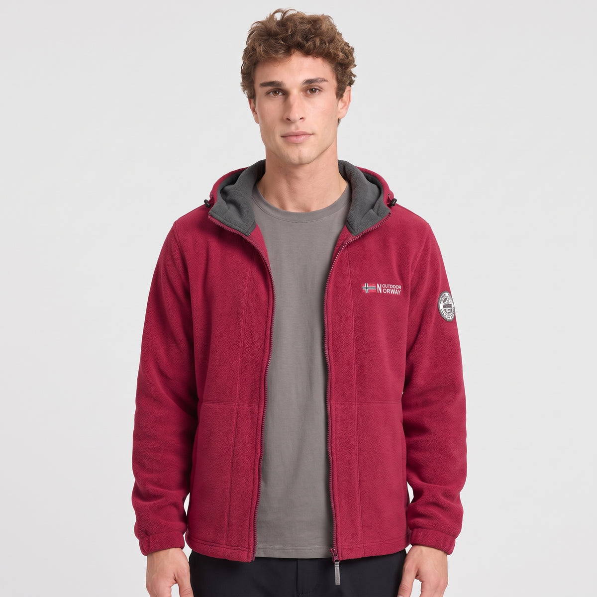 Men's red windproof fleece jacket worn, front view with contrast hood lining
