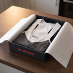 The bib shorts presented in dark branded packaging