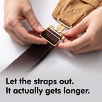 Hands adjusting the buckle on the crossback strap of the canvas bib dungarees