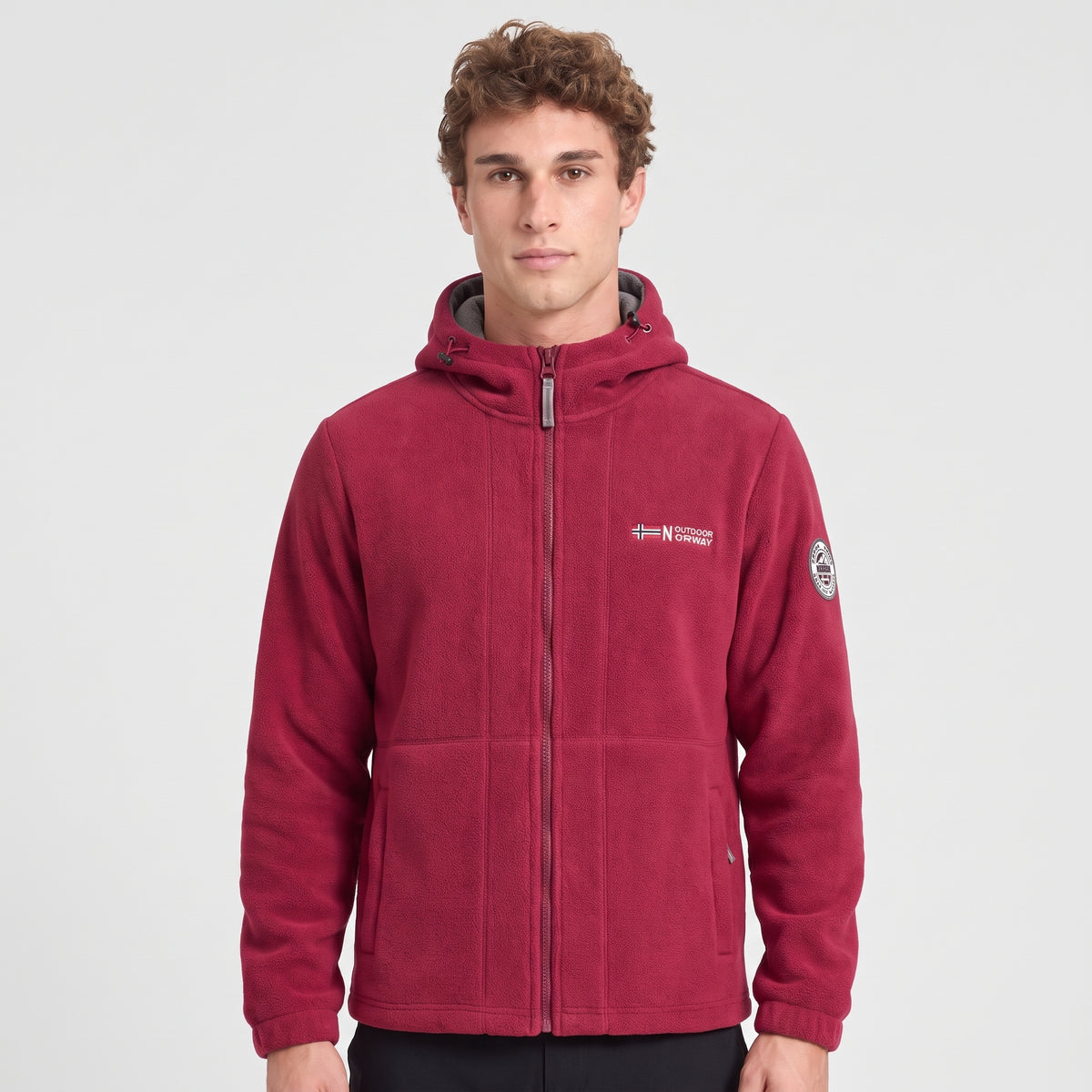 Men's red windproof fleece jacket worn zipped up, front view