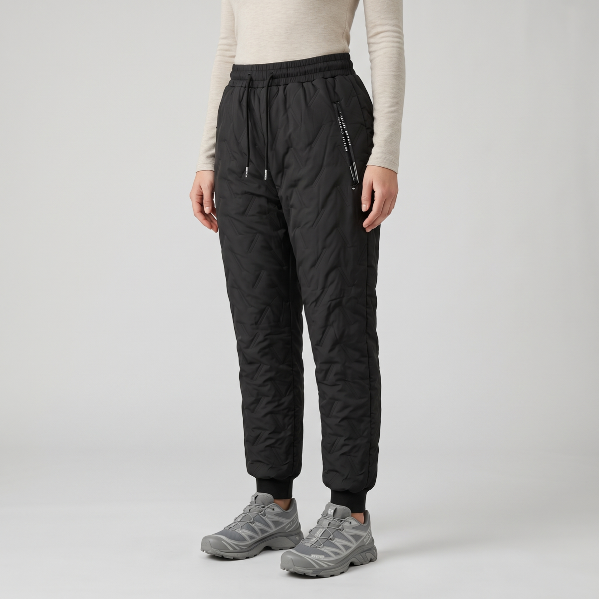 Women's fleece lined quilted trousers worn, Black, cuffed ankle, front view