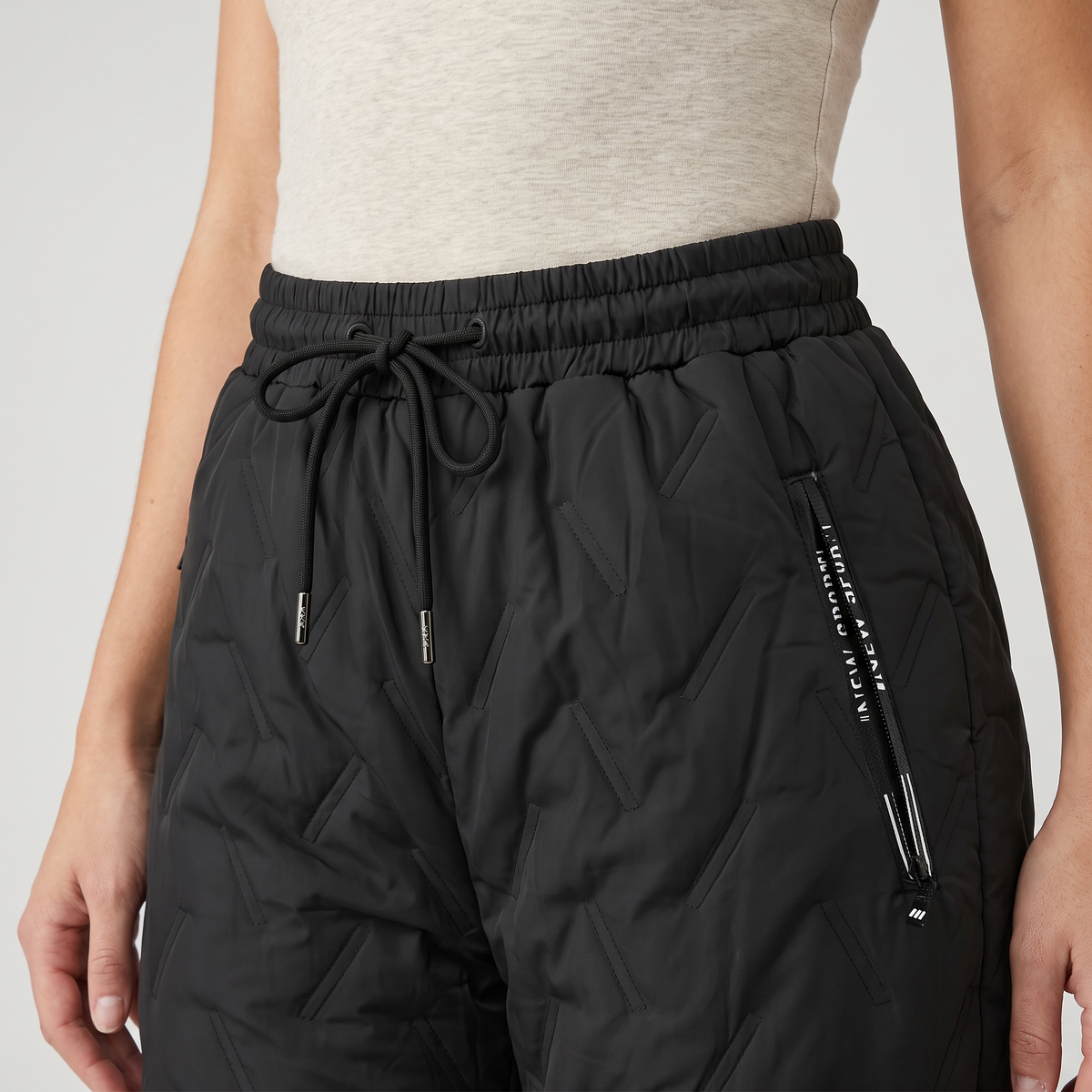 Women's fleece lined quilted trousers: drawcord waist and zipped hip pocket close-up