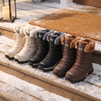 Beige, Black and Brown fur lined snow boots on a snowy porch step