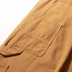 Reinforced back pocket on the camel canvas bib dungarees
