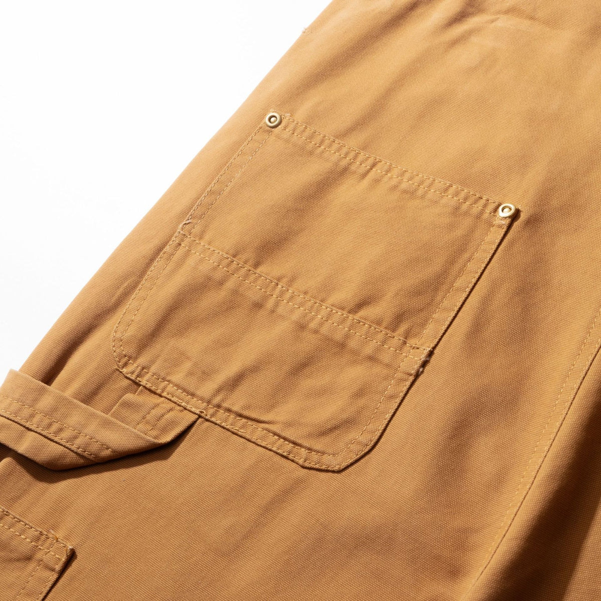 Reinforced back pocket on the camel canvas bib dungarees