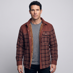 Man wearing the men's fleece lined check overshirt in Rust Red over a grey T-shirt