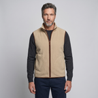 Man wearing the khaki men's fleece vest over a long-sleeved top, front