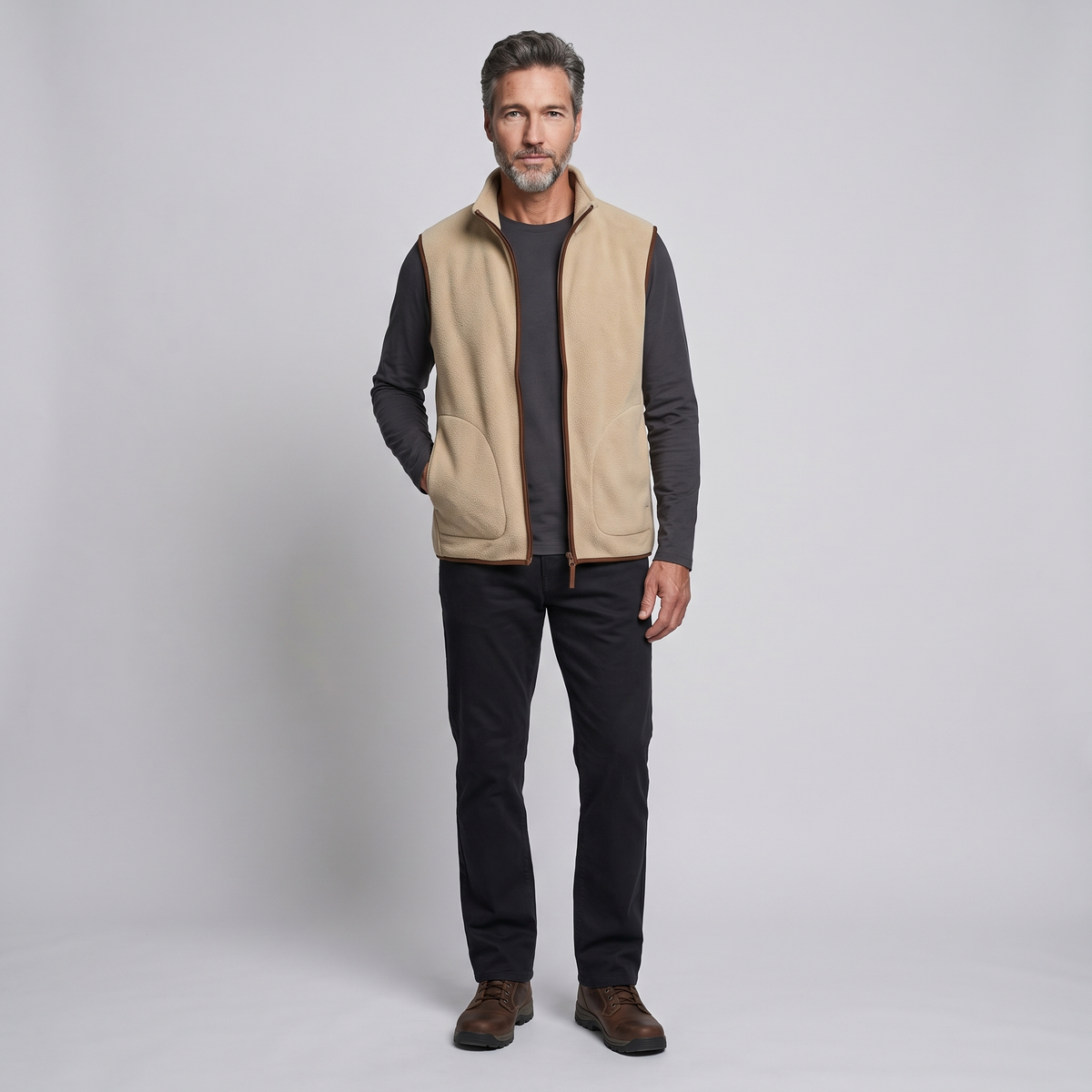 Khaki men's fleece vest worn with dark trousers, full length