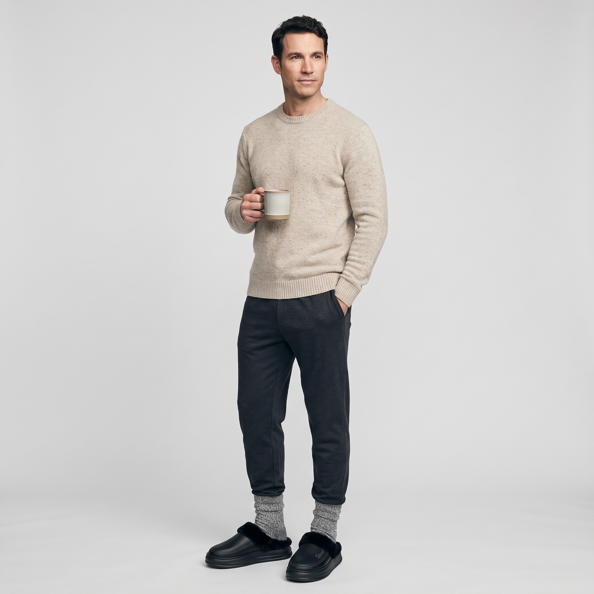 Man wearing the black fur lined slipper clogs with grey wool socks