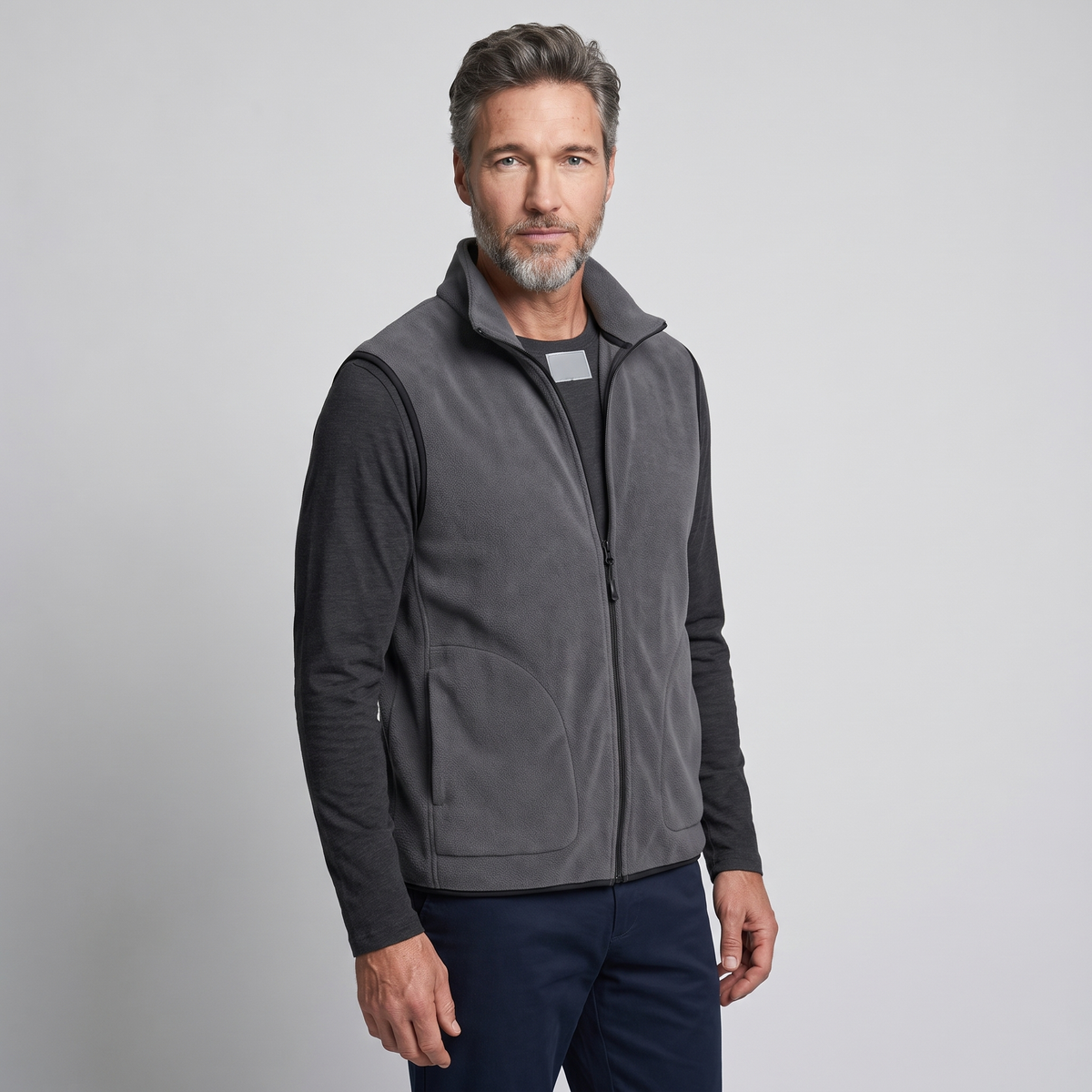 Charcoal men's fleece vest worn, three-quarter side view