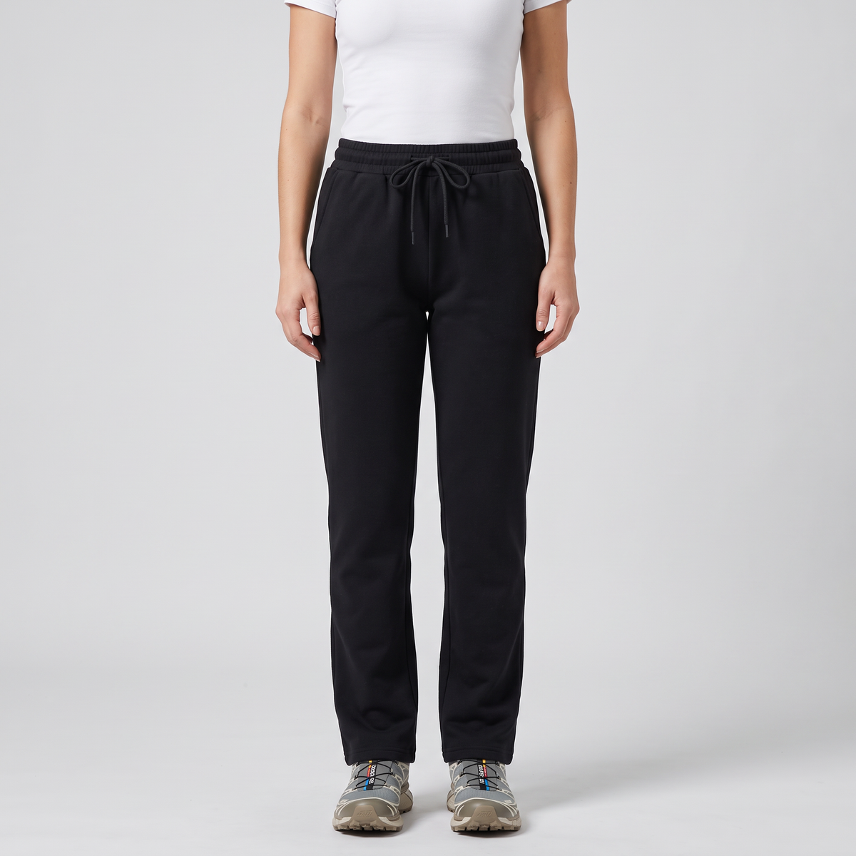 Woman wearing the black fleece lined straight leg joggers, front view from chest to shoes