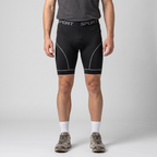 Man wearing the grey men's padded cycling liner shorts, front view from chest to shoes