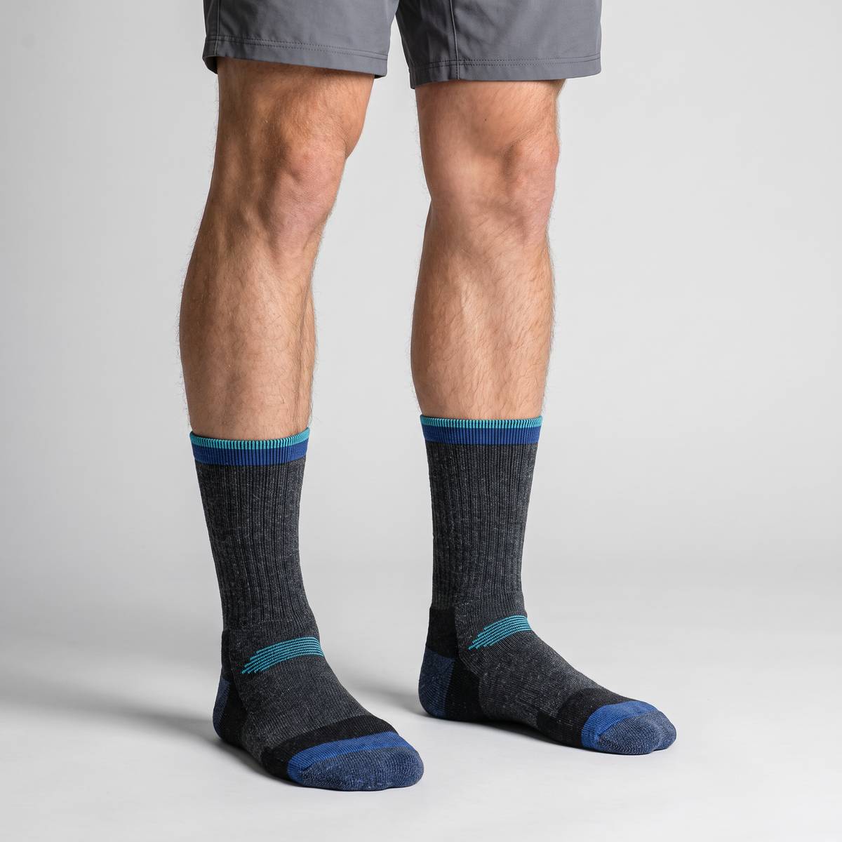 Navy ski socks worn at crew height, front view of the cuff on the leg