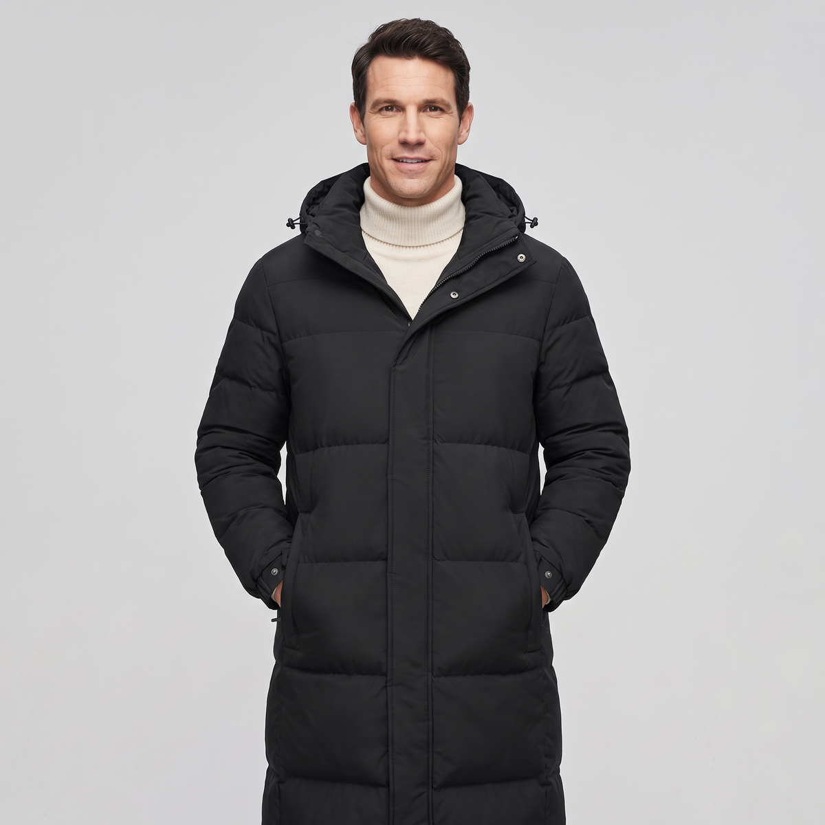 Man wearing the men's long puffer coat in Black, studio front view