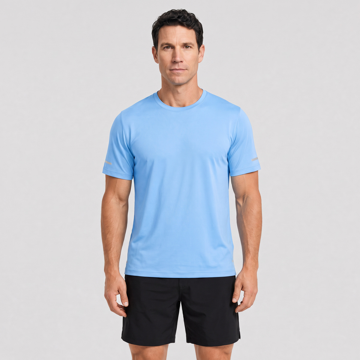 Man wearing the men's running top in Sky Blue, studio front view