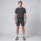 Man wearing the grey padded cycling liner shorts with a t-shirt and trail shoes, full length