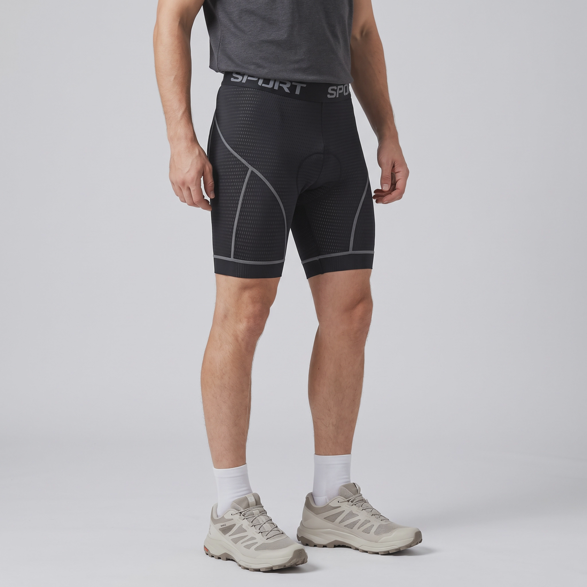 Three-quarter side view of the grey padded cycling liner shorts worn, mid-thigh leg length
