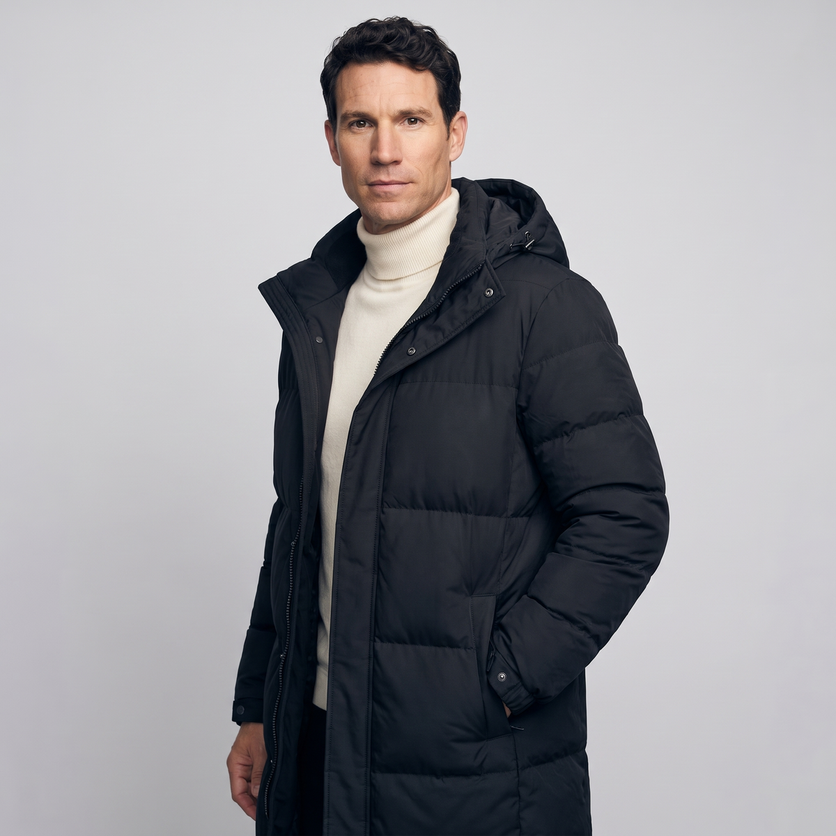 Man wearing the black long puffer coat, three-quarter side view