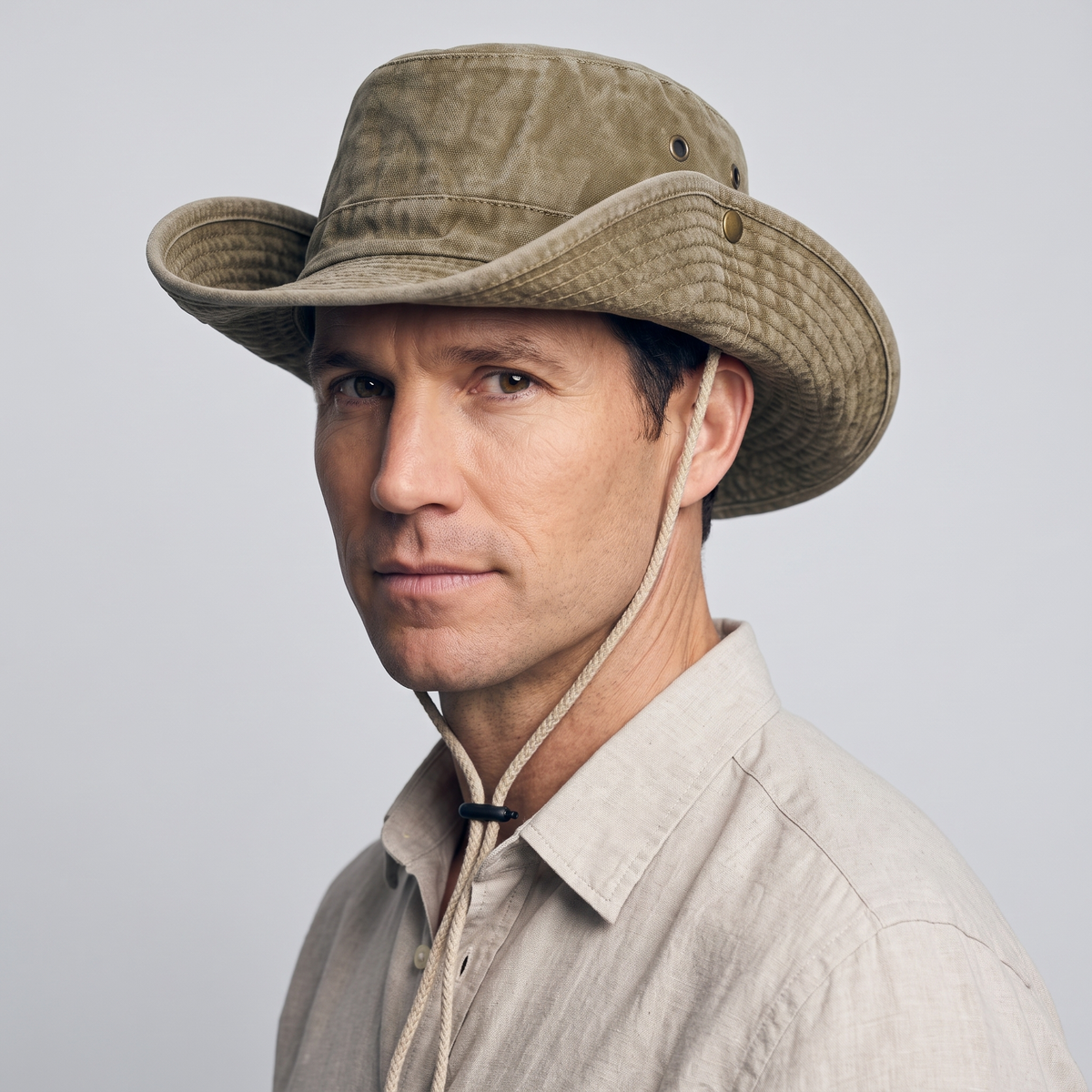 Man wearing the Khaki wide brim sun hat with both side brims snapped up