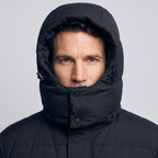 Insulated hood with drawcord toggle drawn in around the face