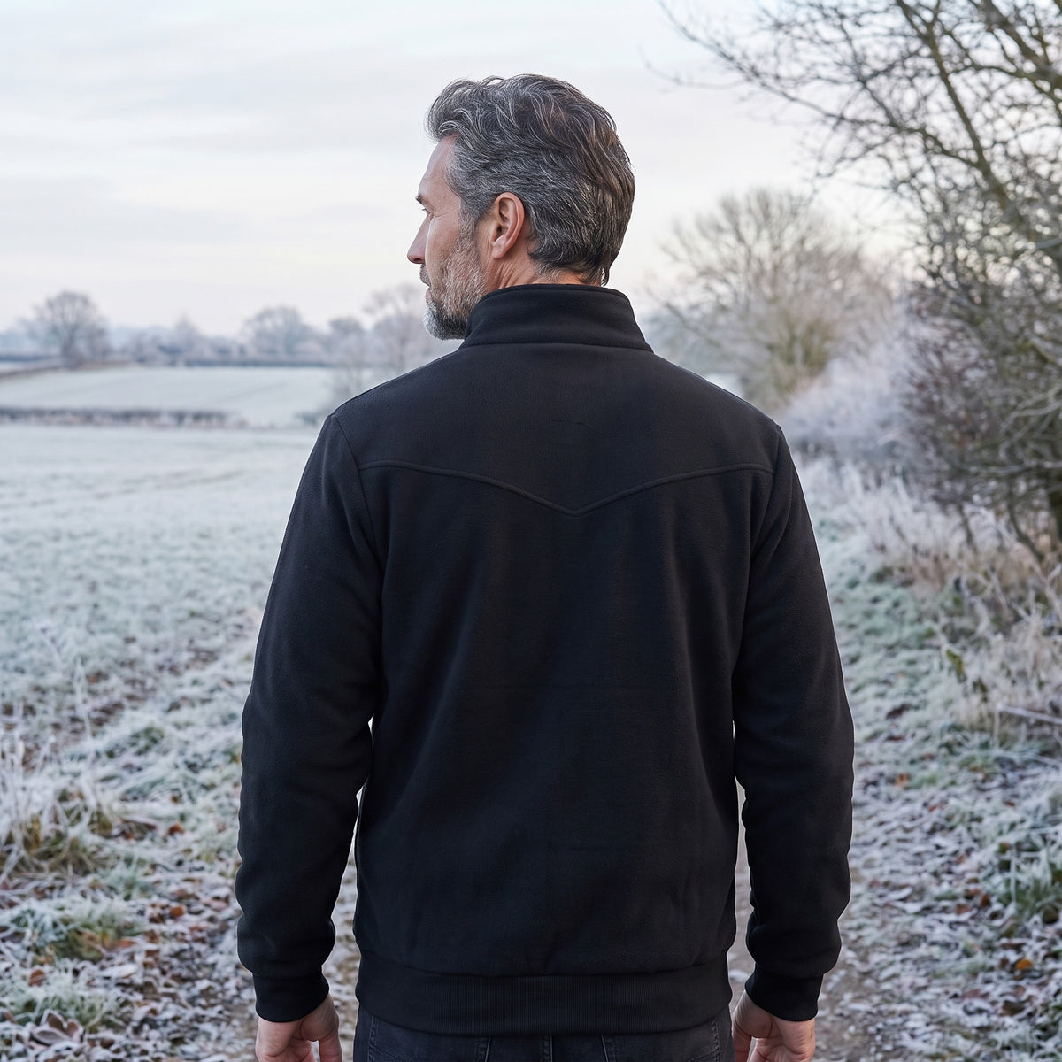 Heated jacket back view worn on a frosty footpath