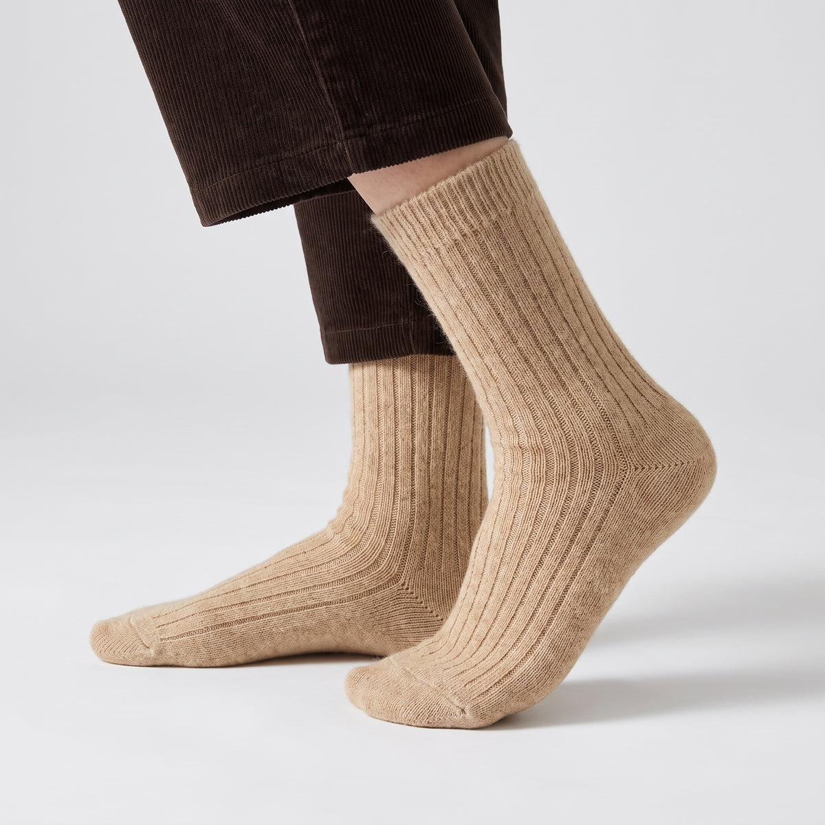 Oatmeal wool socks worn by a woman