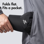 Running cap pressed flat and slid into a jacket pocket